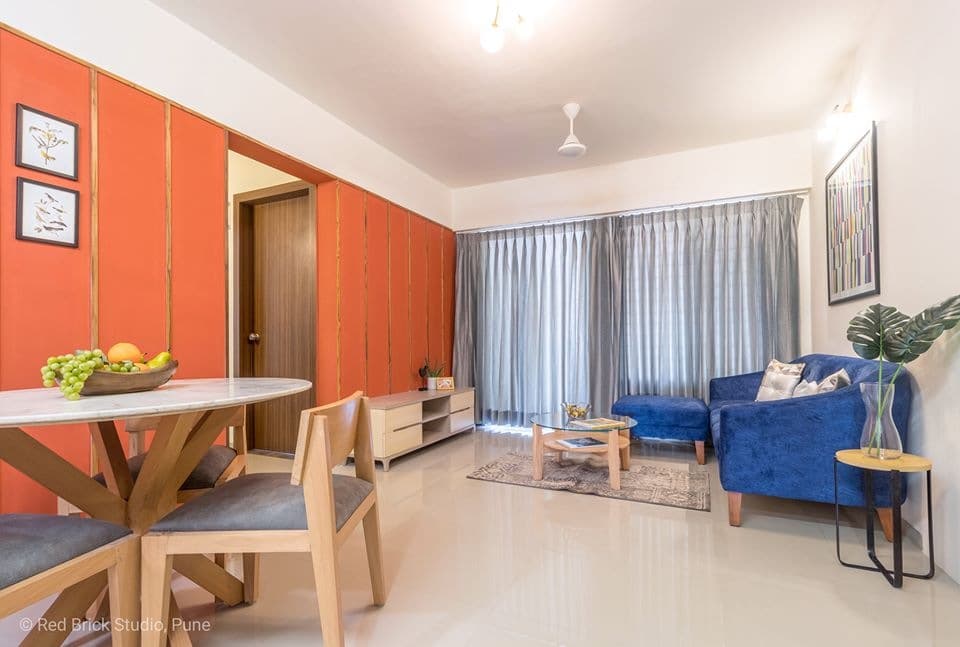 Open-Concept-Living-Dining-Room-comprises-of-Blue-Shaded-Tufted-Upholstered-Modular-Sofa-with-Wooden-Legs-1 Design Detail Banner 0