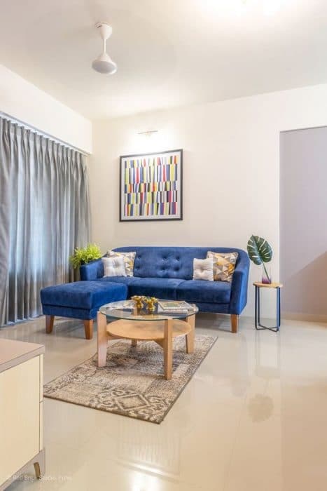 Open-Concept-Living-Dining-Room-comprises-of-Blue-Shaded-Tufted-Upholstered-Modular-Sofa-with-Wooden-Legs-4 Design Detail Banner 3