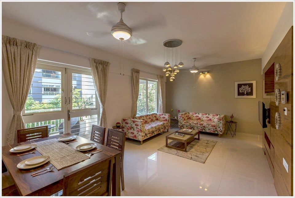 Open-Concept-Living-Dining-Room-comprises-of-Floral-Fabric-Upholstered-Square-Armed-Sofas-1 Design Detail Banner 0