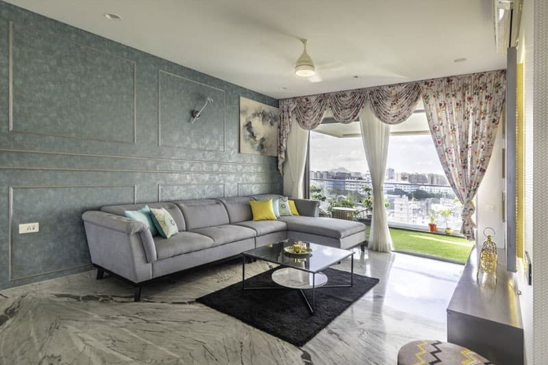 Open-Concept-Living-Dining-Room-comprises-of-Light-Grey-Shaded-Upholstered-L-Shaped-Sectional-Sofa-with-Right-Facing-Chaise-Metal-Base-Colourful-Cushions-2 Design Detail Banner 1