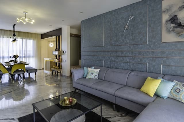 Open-Concept-Living-Dining-Room-comprises-of-Light-Grey-Shaded-Upholstered-L-Shaped-Sectional-Sofa-with-Right-Facing-Chaise-Metal-Base-Colourful-Cushions-3 Swiper Content 2