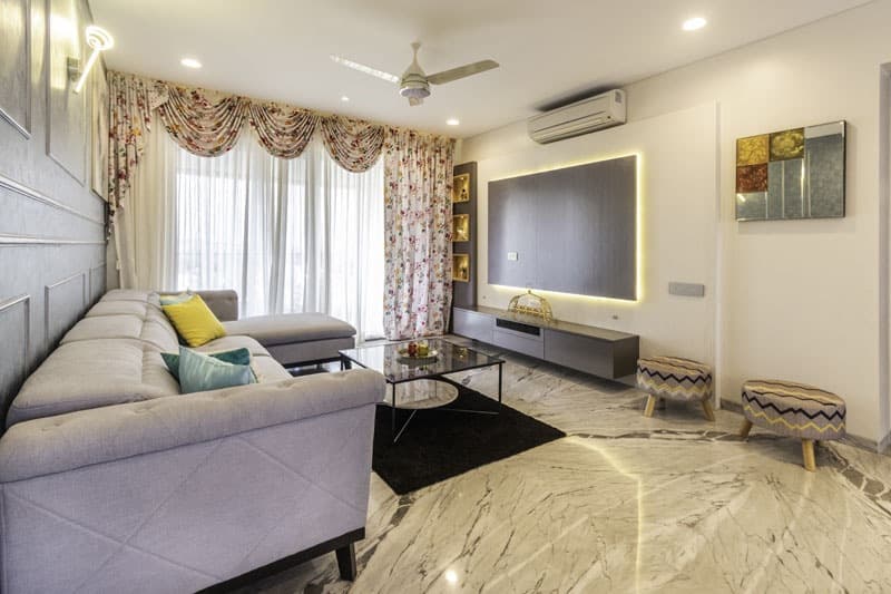 Open-Concept-Living-Dining-Room-comprises-of-Light-Grey-Shaded-Upholstered-L-Shaped-Sectional-Sofa-with-Right-Facing-Chaise-Metal-Base-Colourful-Cushions-4 Design Detail Banner 3