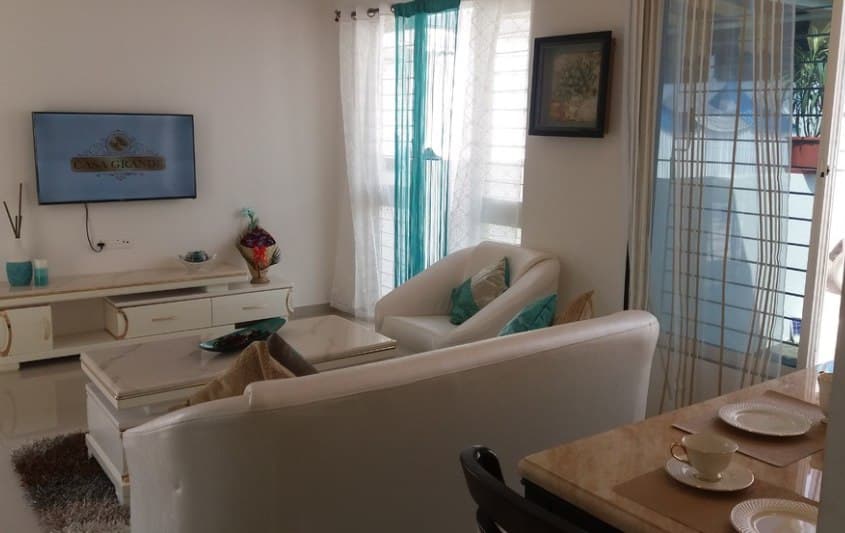 Open-Concept-Living-Dining-Room-comprises-of-White-Leather-Upholstered-Slanted-Armed-Sofa-Set-with-Printed-Cushion-Center-Table-with-Marble-Top-2 Design Detail Banner 1