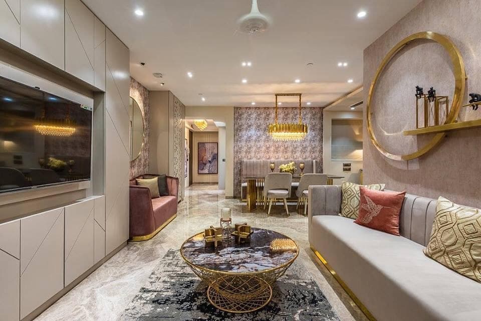 Open-Concept-Living-Dining-Room-incorporates-Linear-Upholstered-Sofa-with-Golden-Metal-Base-Printed-Cushions-Golden-Metal-Circular-Center-Table-with-Glass-Top Design Detail Banner 0