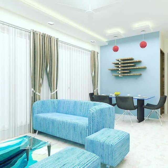 Open-Concept-Living-and-Dining-Room-comprises-of-Upholstered-Blue-Fabric-Square-Armed-Tuxedo-Sofa-with-Metal-Legs-Square-Ottomans-Coffee-Table-TV-Unit-Wall-Touch-4-Seater-Dining-Table Swiper Content 1