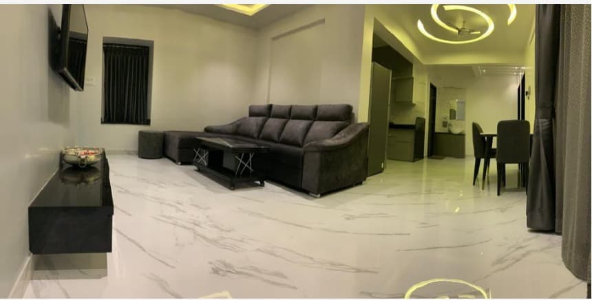 Open-Living-Dining-Concept-with-Dark-Grey-Shaded-Sloped-Arm-Upholstered-Sectional-Sofa-with-Right-Arm-Facing-Chaise-Wooden-Center-Table-Wall-Mounted-TV-with-Wall-Mounted-TV-Cabinet Living Room