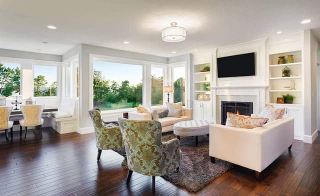 Open-Plan-Concept-of-Living-Dining-in-Off-white-Theme-incorporating-Square-Armed-Sofa-Set-Sofa-Chairs-Oval-Coffee-Table-placed-on-a-Rug Swiper Content 0