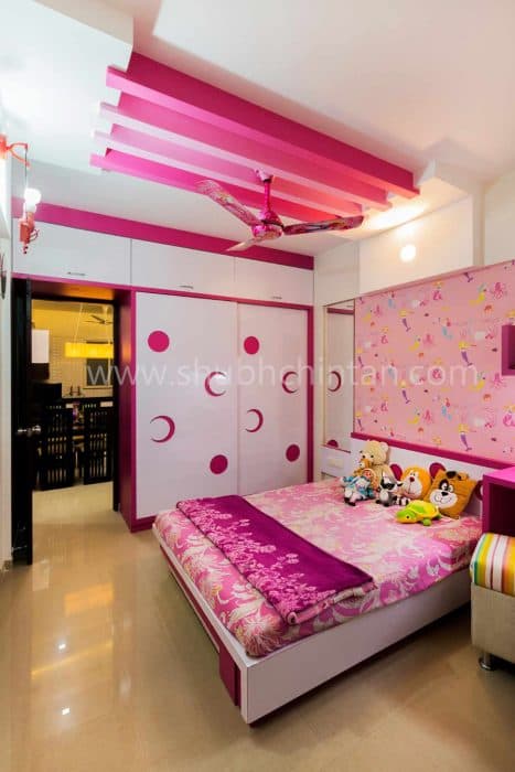 Pink-Coloured-Childrens-Bedroom-with-Wooden-Double-Bed-Wooden-Headboard-Bed-Back-Wall-with-Barbie-Themed-Pink-Wallpaper Swiper Content 1