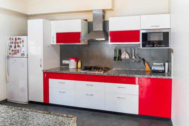 Red-White-Theme-Single-Wall-Kitchen-with-a-Parallel-Island-consist-of-Granite-Countertops-Built-in-Stove-with-Chimney-Built-in-Oven-at-the-Upper-Cabinets Swiper Content 0