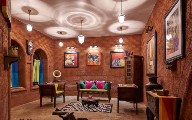 Rustic-Living-Room-incorporating-Wooden-Tuxedo-Sofa-Set-Round-Center-Table-placed-on-a-Modern-Printed-Rug Swiper Content 0