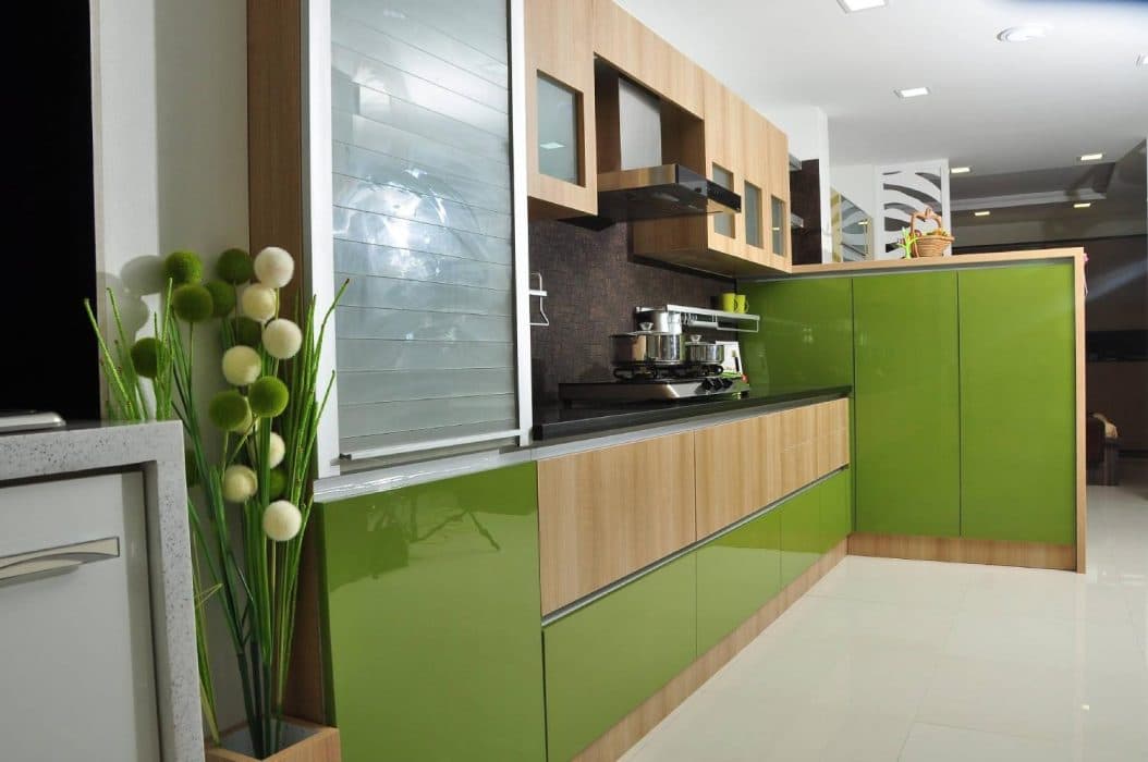 Single-Wall-Kitchen-consists-Combination-of-Olive-Green-Colour-Wooden-Finish-with-a-Black-Granite-Platform-holding-2-Burner-Gas-Stove-with-Chimney-above. Design Detail Banner 0