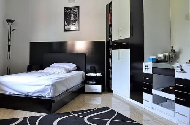 Small-Bedroom-in-Black-White-Theme-with-Wooden-Flooring-comprises-of-Single-Wooden-Bed Swiper Content 0