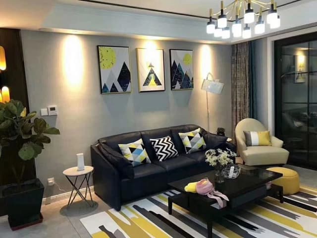 Small-Contemporary-Living-Room-designed-with-Black-Coloured-Leather-upholstered-Sofa-Offwhite-Coloured-Sofa-Chair-1 Swiper Content 0