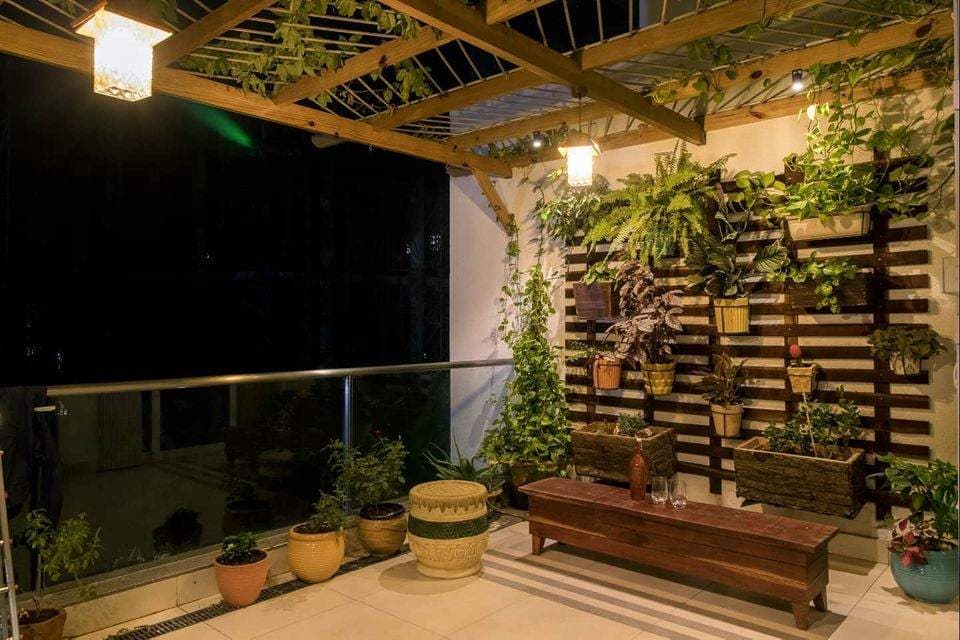 The-Balcony-consist-of-Vertical-Garden-Potted-Plants-Small-Linear-Wooden-Table-with-Round-Stools-Wooden-Pergolas-with-Metal-Rods.-1 Design Detail Banner 0
