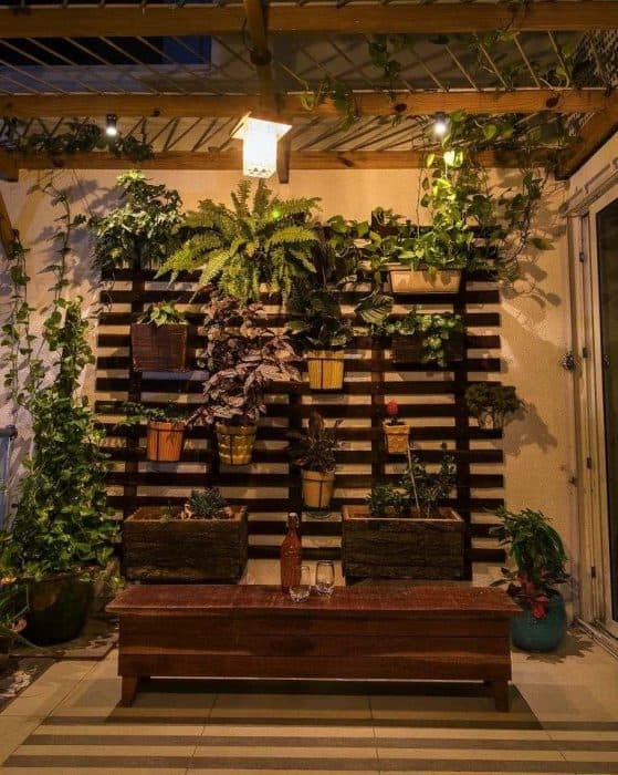 The-Balcony-consist-of-Vertical-Garden-Potted-Plants-Small-Linear-Wooden-Table-with-Round-Stools-Wooden-Pergolas-with-Metal-Rods.-2 Design Detail Banner 1