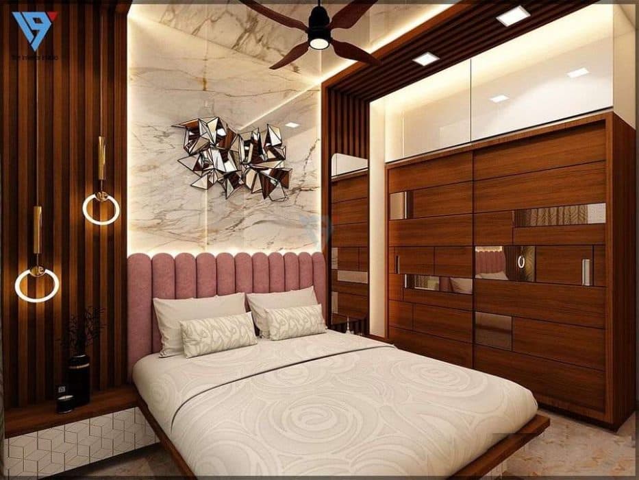 The-Bed-is-Place-Single-Side-of-the-Bedroom-Consists-of-Wooden-Panel-Storage-Space-on-One-Side-Side-Table-on-the-Other-Side. Design Detail Banner 0