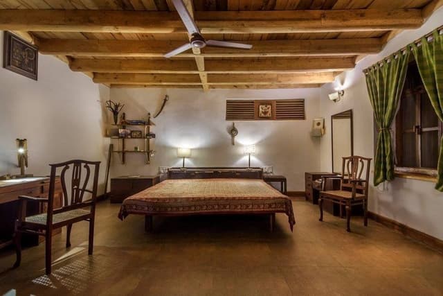 The-Traditional-Style-Bedroom-with-Wooden-Ceiling-Stone-Flooring-is-making-it-Simple-Elegant. Bedroom