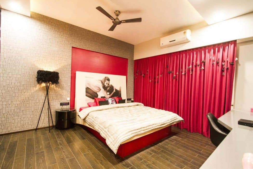 The-pink-colour-of-the-Bed-Pink-Curtains-with-pom-pom-hangings-the-wall-with-Photo-Frame-Standing-Lamp-with-Feather-Lampshade Design Detail Banner 0