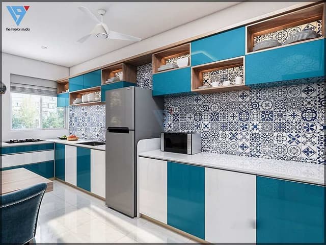 This-Kitchen-has-an-L-Shape-Counter-Top-Finish-with-White-Stone. Swiper Content 0