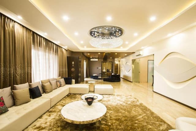 This-Luxurious-Living-Space-Consists-White-Sectional-Sofa-with-Cushions.-Multilevel-Circular-Center-Table-with-Metal-Frame-Floor-Rug-is-Functionally-Supporting-the-Space.-3 Swiper Content 2