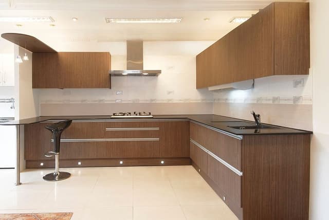 This-Monochromatic-Kitchen-has-L-Shape-Black-Kitchen-Countertop Swiper Content 0