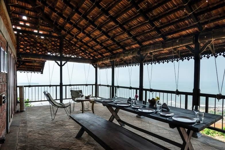 This-Vernacular-Semi-Covered-Balcony-has-a-Portable-Wooden-Dining-Table-with-Bench-Style-Sitting Portable Wooden Dining Table