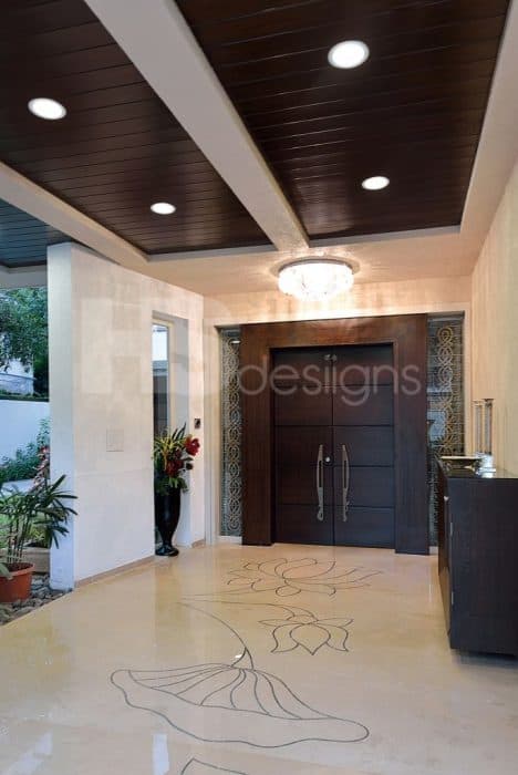 Traditional-Entrance-Wooden-Double-Door-highlighted-by-Grooves-with-Wooden-Frame-Surrounding-it Design Detail Banner 0