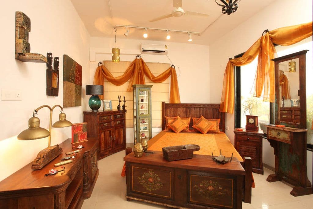 Traditional-Styled-Bedroom-in-the-Neutral-Colour-Scheme-designed-with-Wooden-Bed-Side-Tables-Wooden-Cabinet-with-Table-Lamp-placed-on-it Design Detail Banner 0