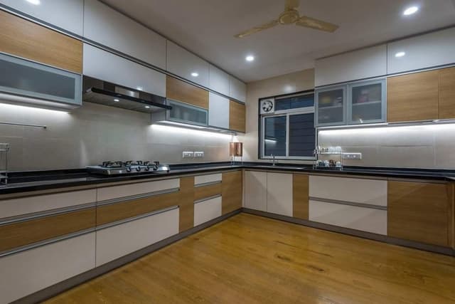 U-Shape-Platform-Kitchen-with-Combination-of-White-Colour-Wooden-finish-is-Going-in-Rhythm-with-the-Wooden-Flooring.-2 Swiper Content 1