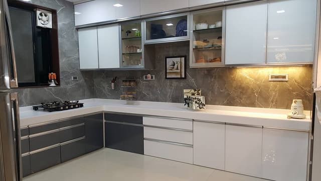 White-Grey-Theme-L-Shaped-Kitchen-designed-with-Acrylic-Polished-Corian-Countertop Swiper Content 0