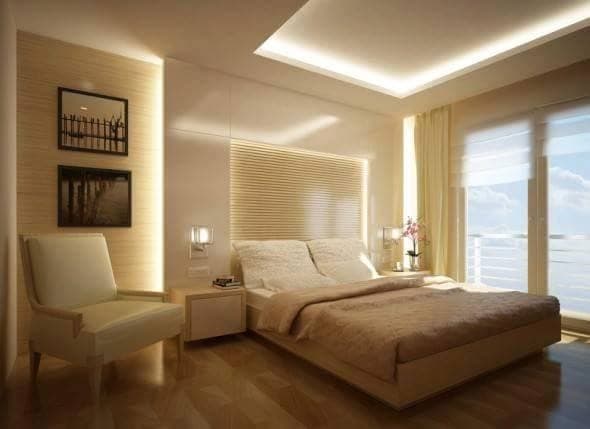 White-Themed-Bedroom-with-Wooden-Bed-Side-Tables-with-Drawers-illuminated-by-Wall-Lights-Bed-Backwall-with-Wooden-Slits-highlighted-with-cove-Lights Design Detail Banner 0