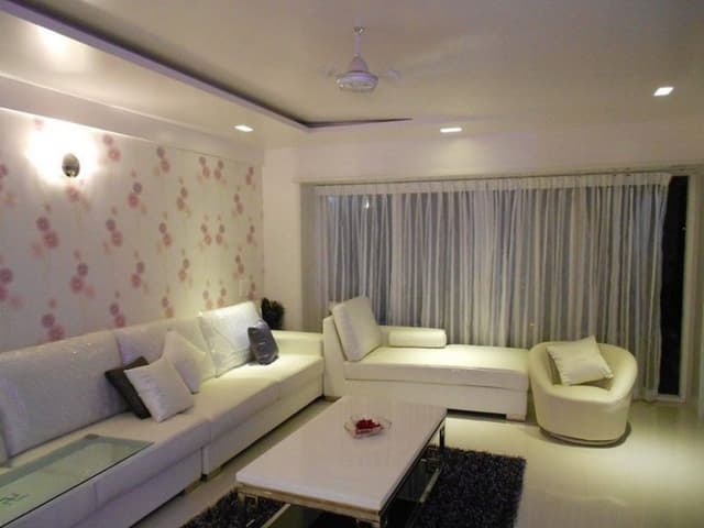 White-Themed-Contemporary-Living-Room-designed-with-Modular-Sofa-Set-incl.-Relaxing-Chaise-Roundback-Sofa-Chair-Coffee-Table-placed-in-a-Fur-Rug Swiper Content 0