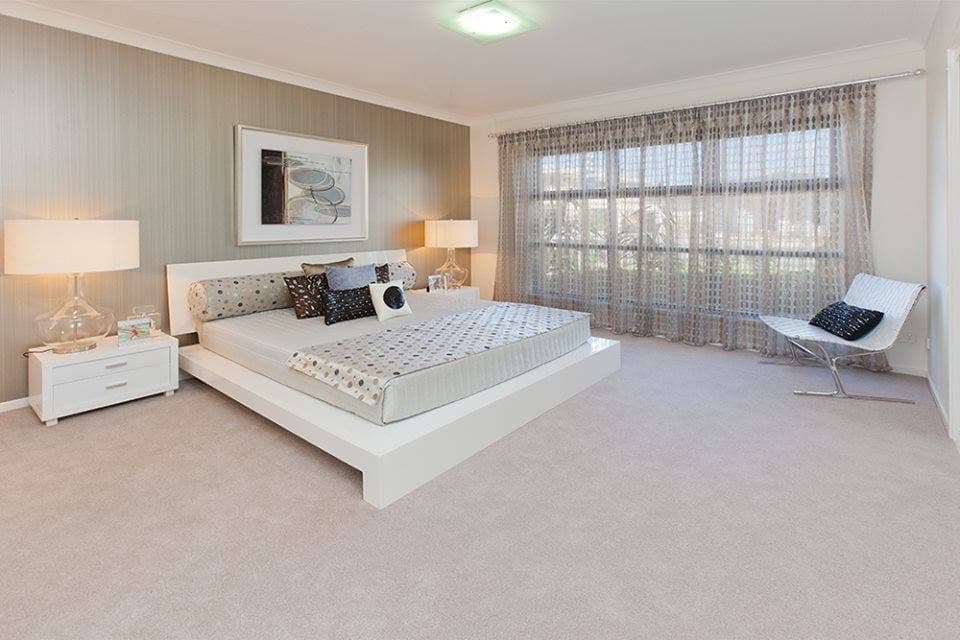 White-Themed-Large-Bedroom-incorporating-Wooden-Bed-Cushioned-Wall-mounted-Headboard-Square-Cylindrical-Cushions Design Detail Banner 0