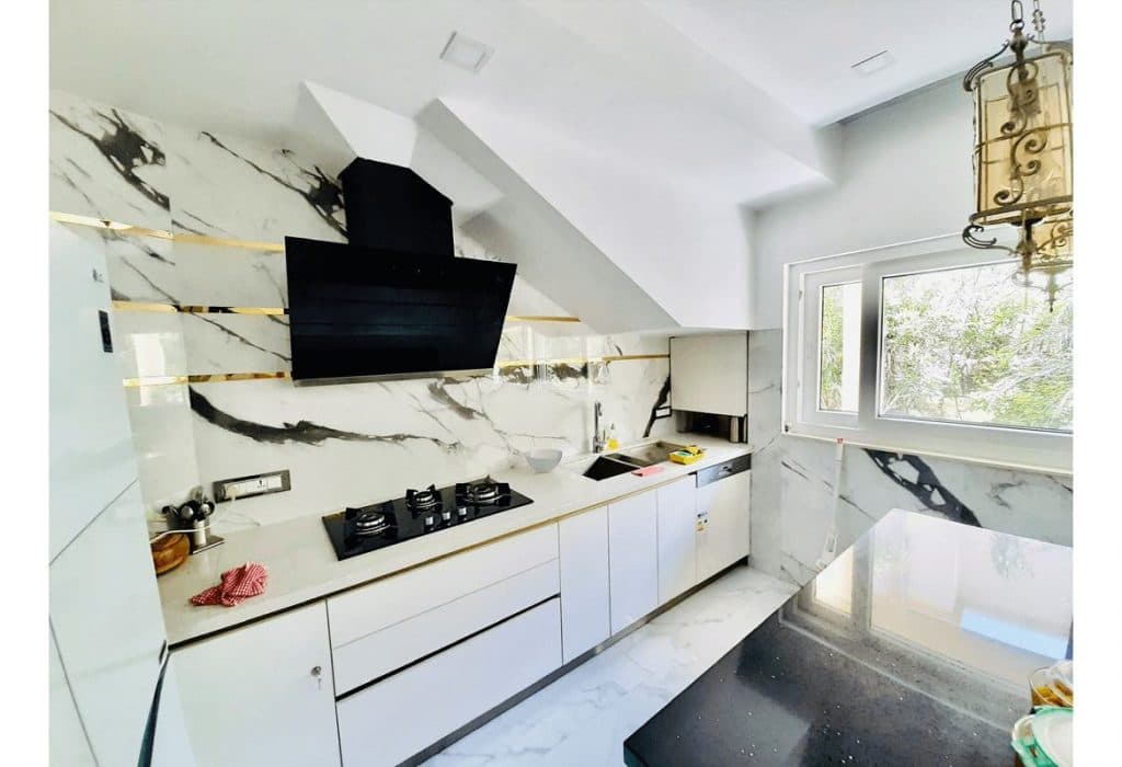 White-Themed-Single-Wall-Kitchen-with-White-Marble-Kitchen-Countertop-Built-in-Stove-with-Chimney-Lower-Kitchen-Cabinets-with-Profile-Handles Design Detail Banner 0