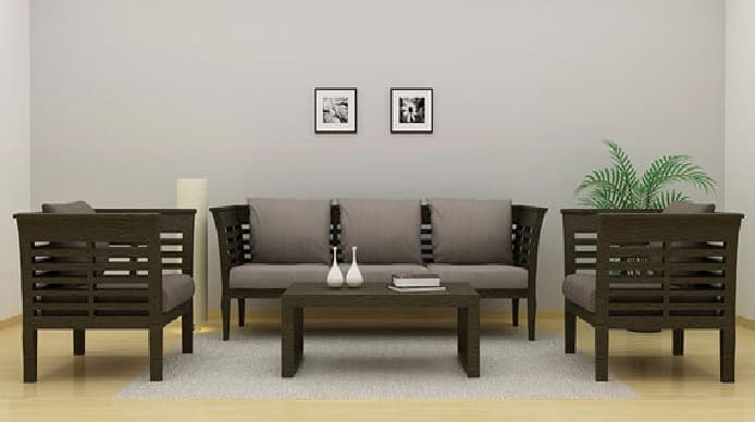 Wooden-Sofa-Set-with-Grey-coloured-Square-Loose-Cushions.-The-Photo-Frame-on-the-Back-Wall-the-Artifacts-on-the-Centre-Table Design Detail Banner 0