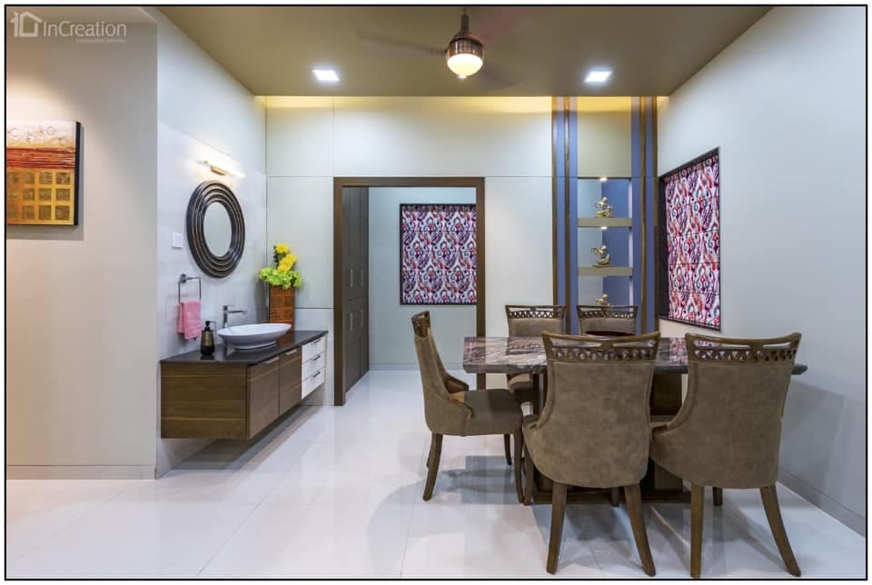 A modern elegant dining area with dining table of reflecting marble top and Victorian styled dining chairs with hemlock upholstery A modern elegant dining area with dining table of reflecting marble top and Victorian styled dining chairs with hemlock upholstery