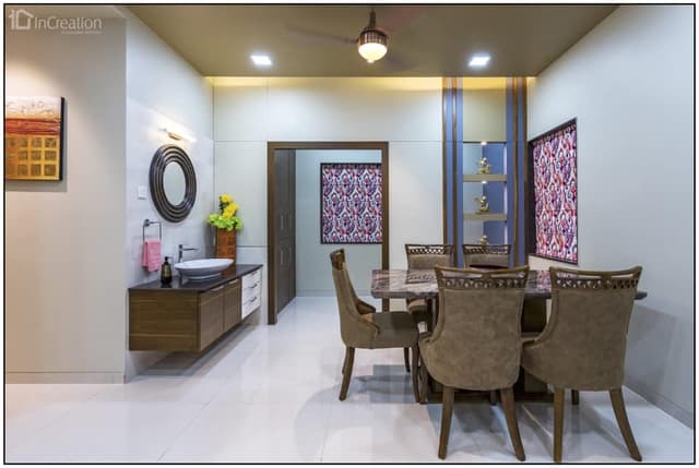 A modern elegant dining area with dining table of reflecting marble top and Victorian styled dining chairs with hemlock upholstery A modern elegant dining area with dining table of reflecting marble top and Victorian styled dining chairs with hemlock upholstery