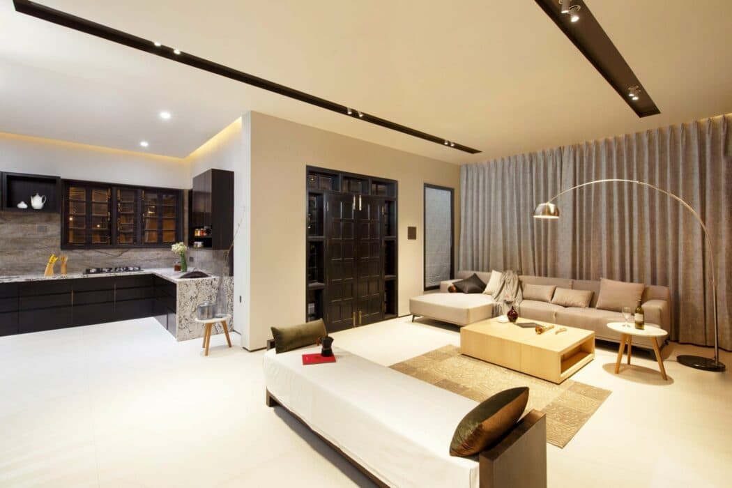 A modern living room with an open kitchen A modern living room with an open kitchen