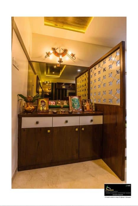 Pooja area with a wooden platform under which there are white drawers Pooja area with a wooden platform under which there are white drawers