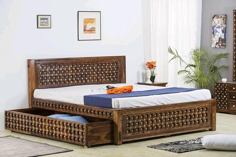 An intricately designed dark wooden bed An intricately designed dark wooden bed