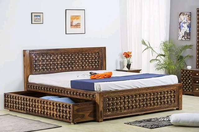 An intricately designed dark wooden bed An intricately designed dark wooden bed
