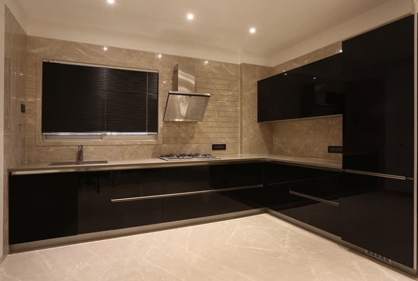 The Black & Beige Kitchen Consists L Shape Counter Top The Black & Beige Kitchen Consists L Shape Counter Top
