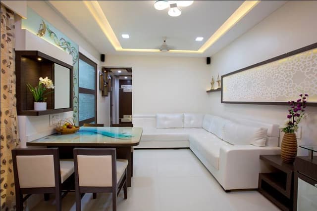 The Compact Living Room with White & Brown Combination has L Shaped White Upholstered Sofa with Wooden Side Table cum Storage Unit – 2 The Compact Living Room with White & Brown Combination has L Shaped White Upholstered Sofa with Wooden Side Table cum Storage Unit - 2