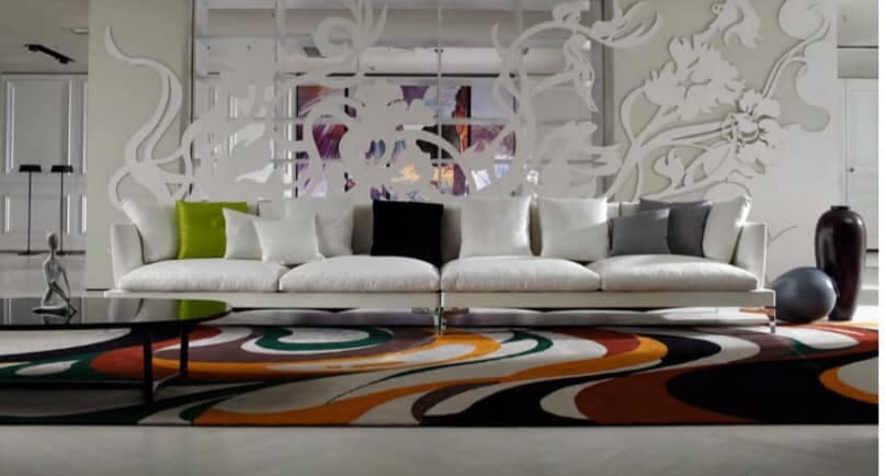 4-Seater White Upholstered Sofa having Metal Legs & Colourful Cushions is nicely placed with the White Jali Partition behind it, with a colourful Floor Rug highlighting the Floor 4-Seater White Upholstered Sofa having Metal Legs & Colourful Cushions is nicely placed with the White Jali Partition behind it, with a colourful Floor Rug highlighting the Floor