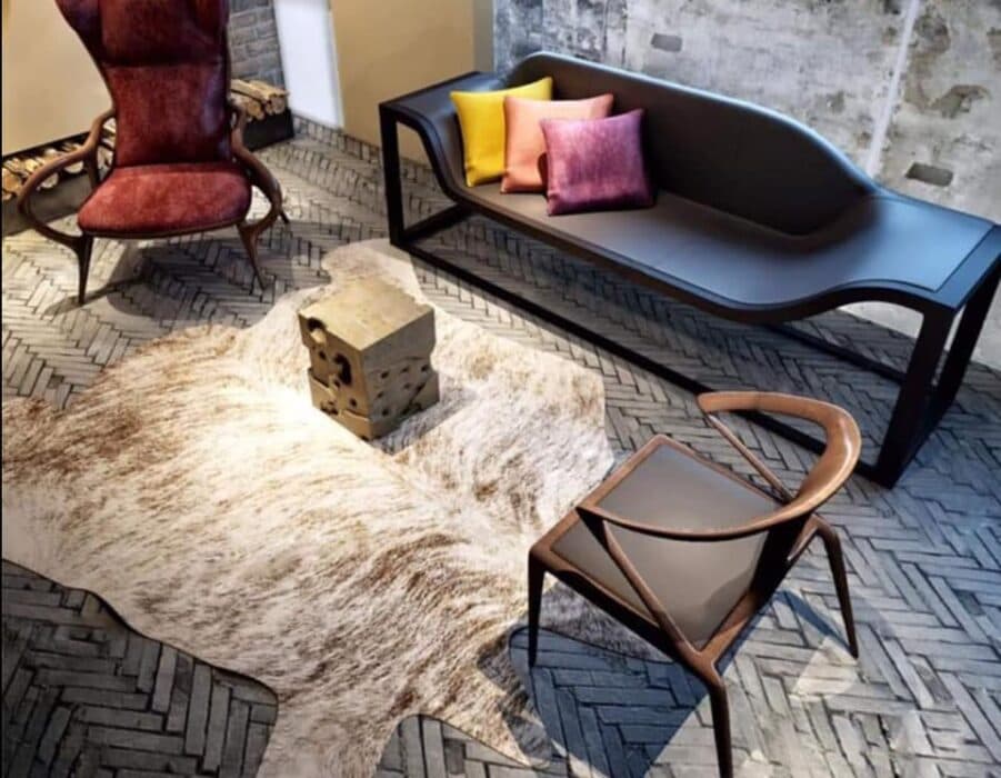 A Unique Black Sofa having Metal Framed Legs with the Maroon High Wingback Chair A Unique Black Sofa having Metal Framed Legs with the Maroon High Wingback Chair