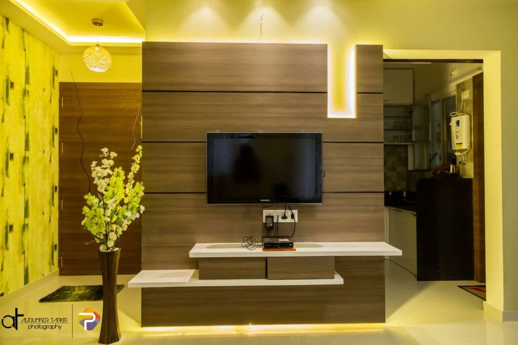 The T.V. Unit serves the Purpose of Partition has Multilevel Wooden Storage at the Bottom with White Top The T.V. Unit serves the Purpose of Partition has Multilevel Wooden Storage at the Bottom with White Top