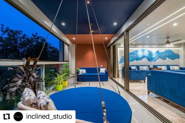 Elegant Indoor-Outdoor Living Space Features a Cosy Swing Elegant Indoor-Outdoor Living Space Features a Cosy Swing